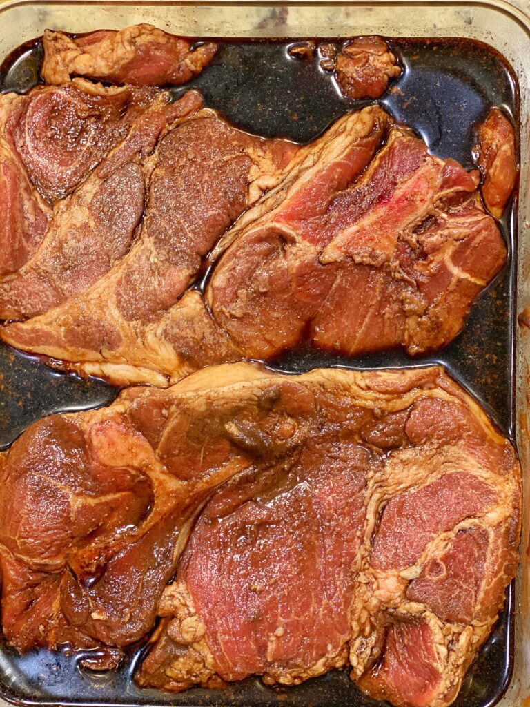 Pork shoulder steaks marinating