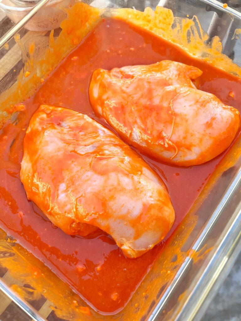 Chicken breasts marinating in TRUFFalo sauce