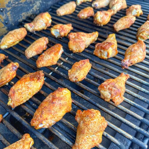 Chicken wings smoking on the Traeger grill.