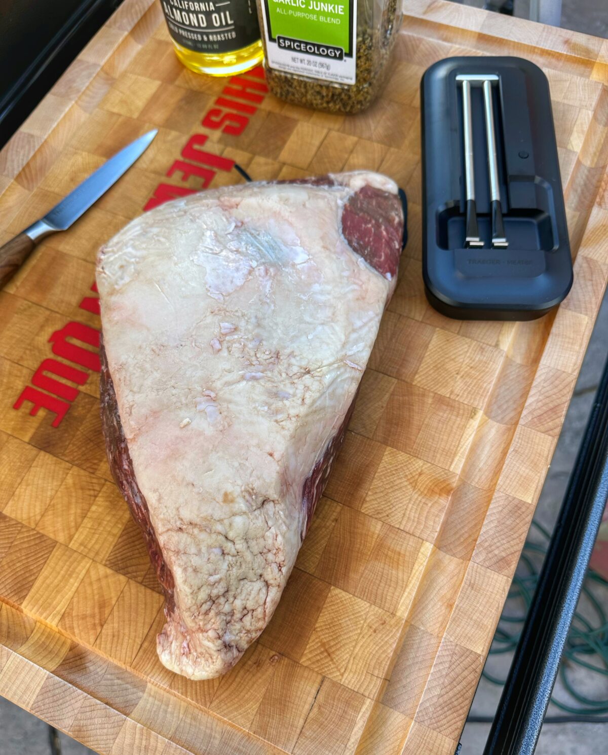 Raw picanha roast on a cutting board.