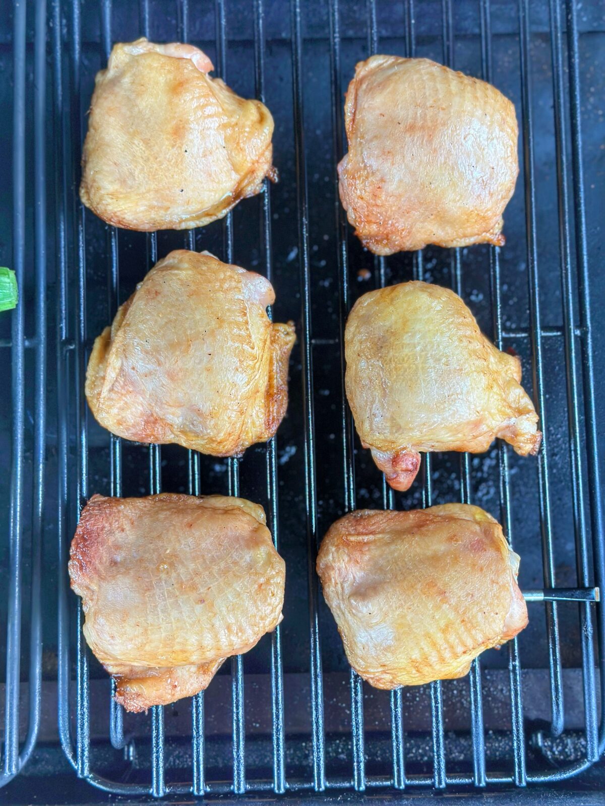 Six chicken thighs on the Traeger grill.