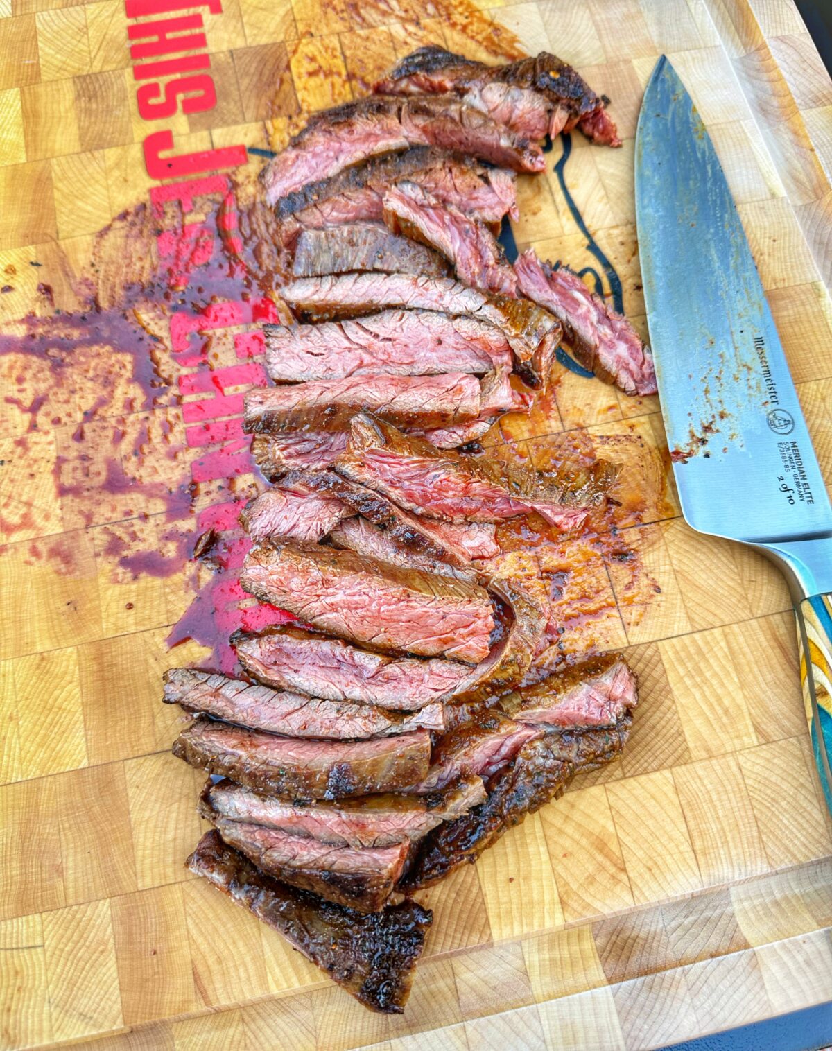 Medium rare steak slices on a cutting board.
