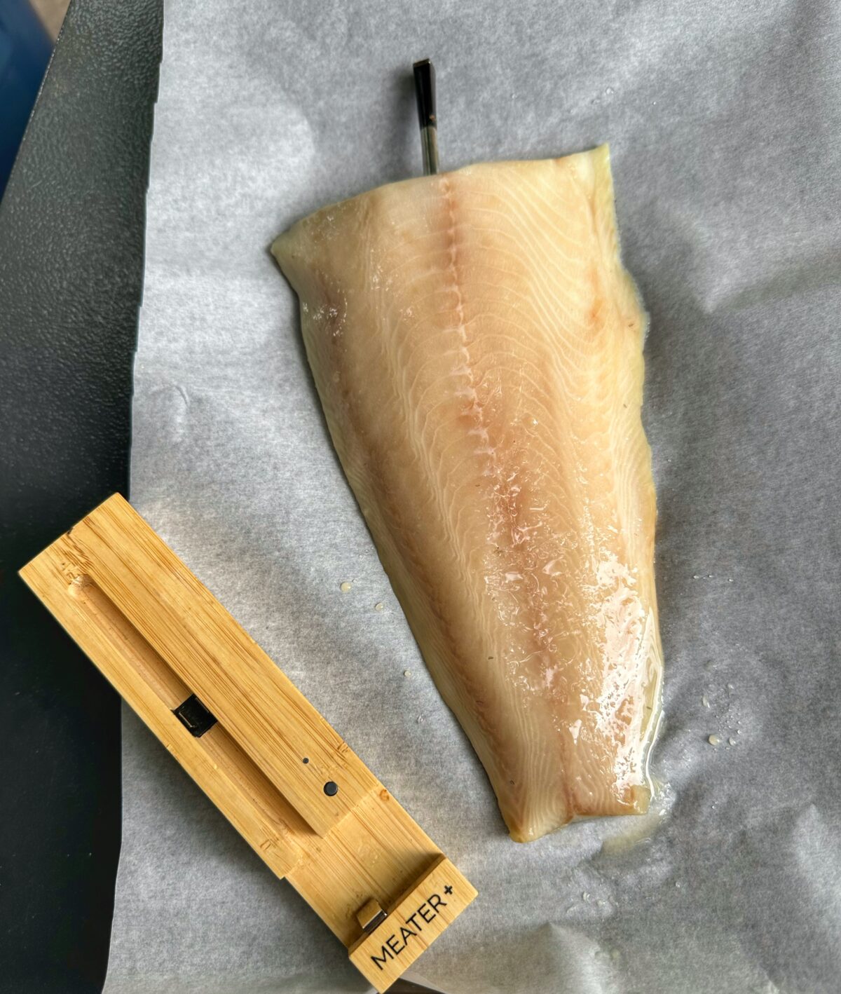 Filet of black cod with a Meater Thermometer.