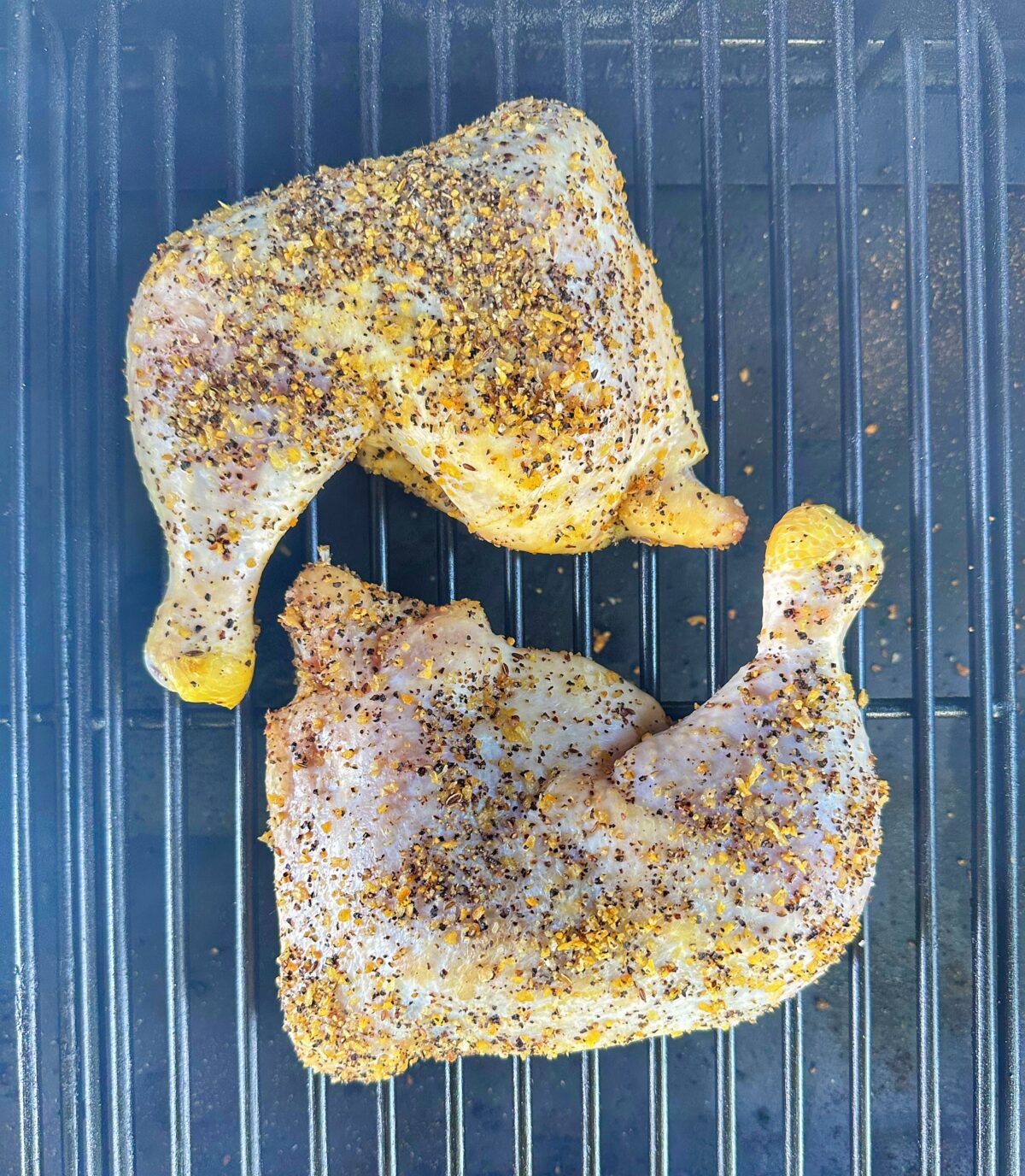 Two chicken quarters smoking on the Traeger.