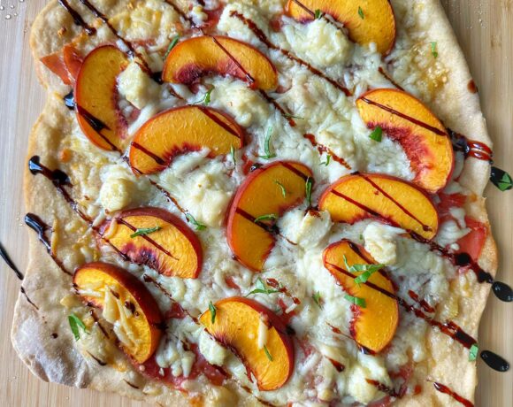 Finished pizza with peaches drizzled in balsamic.