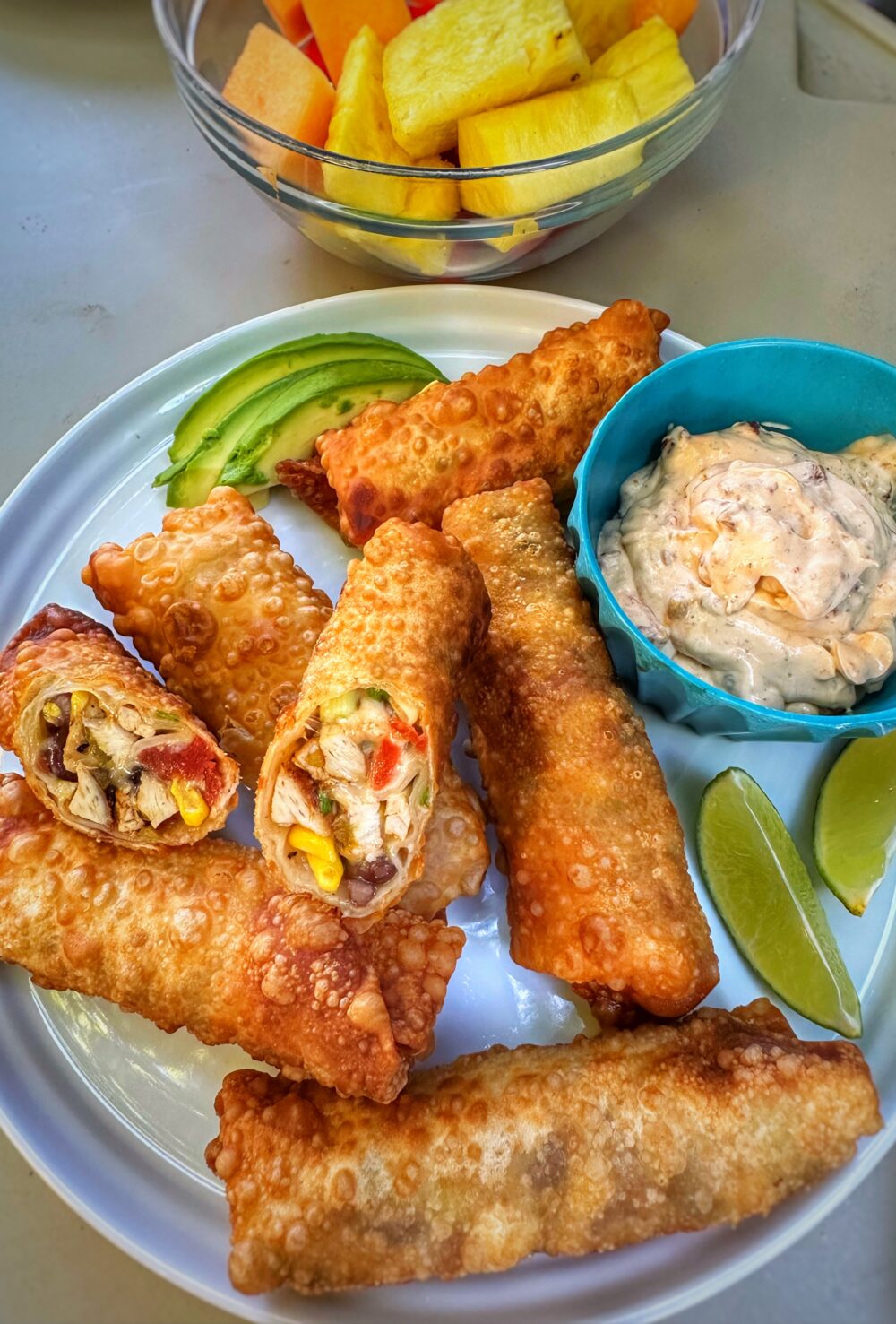 A plate of finished southwest egg rolls on a plate with garnish.