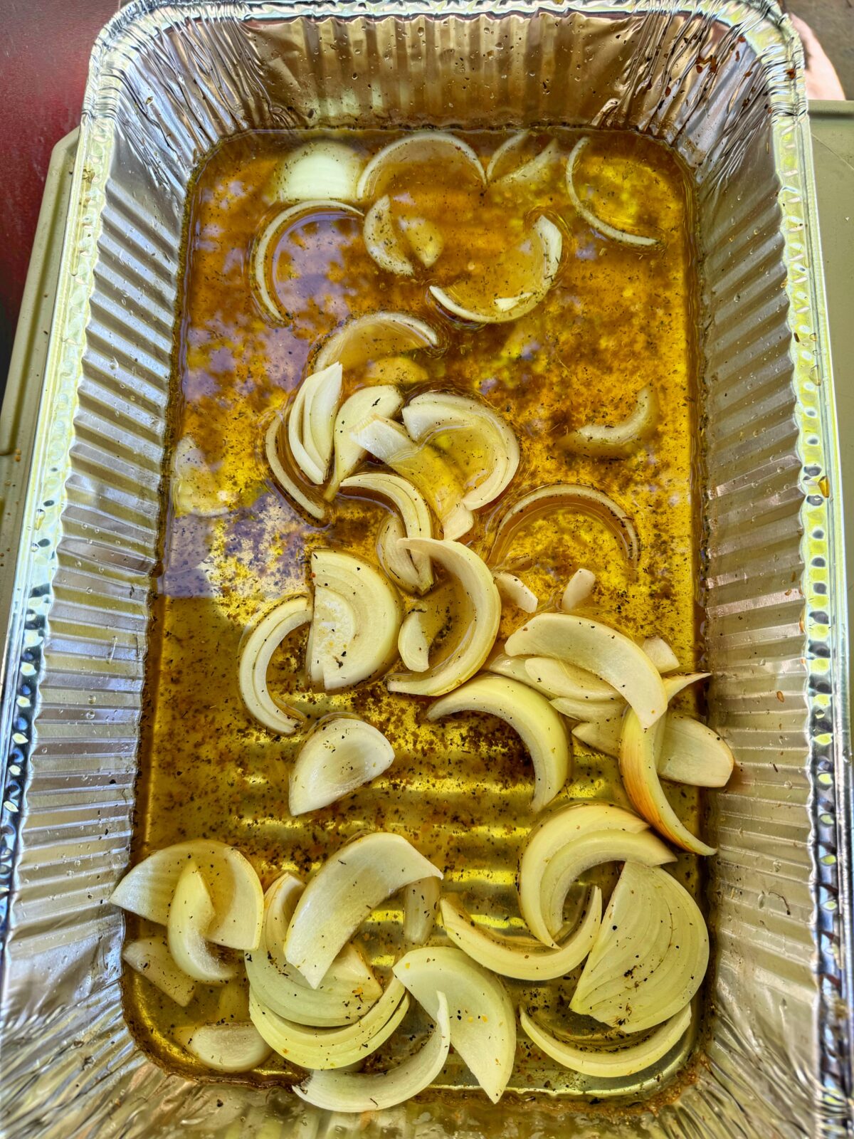 A pan of braise liquid and onions.