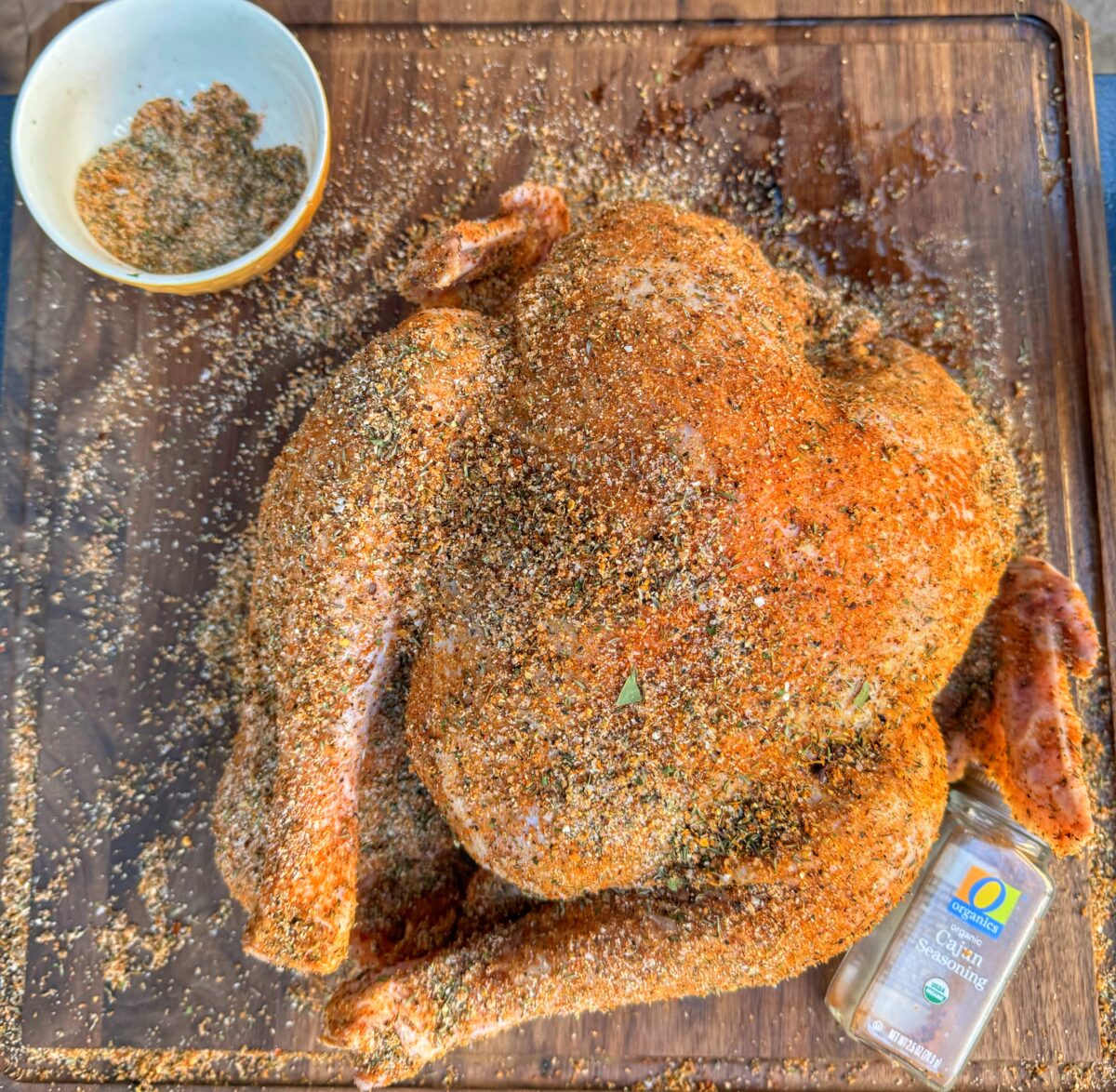 A turkey seasoned generously in cajun seasoning.