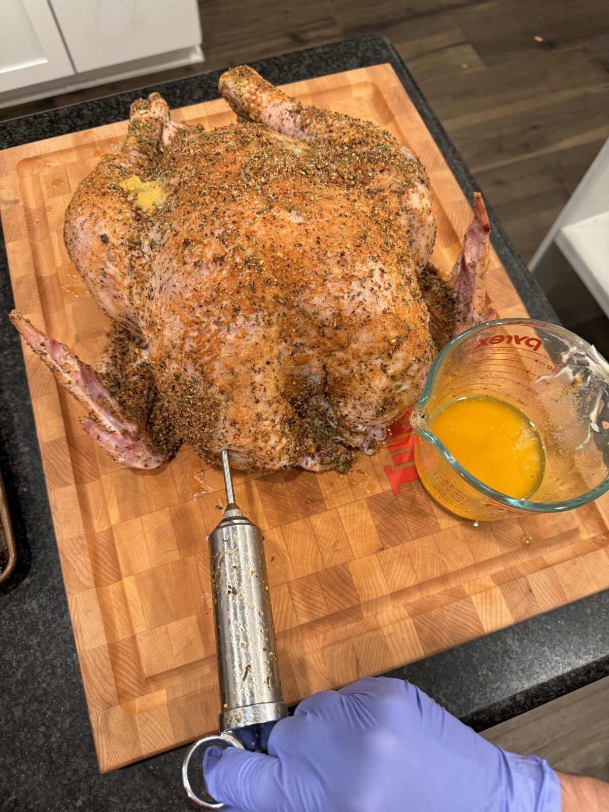 Injecting a turkey with cajun butter.