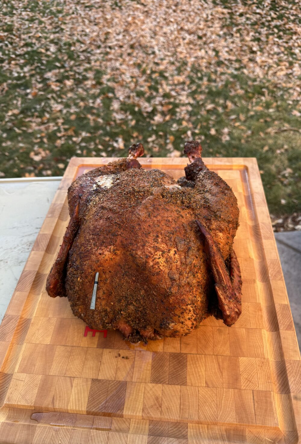 A smoked cajun turkey on a cutting board.
