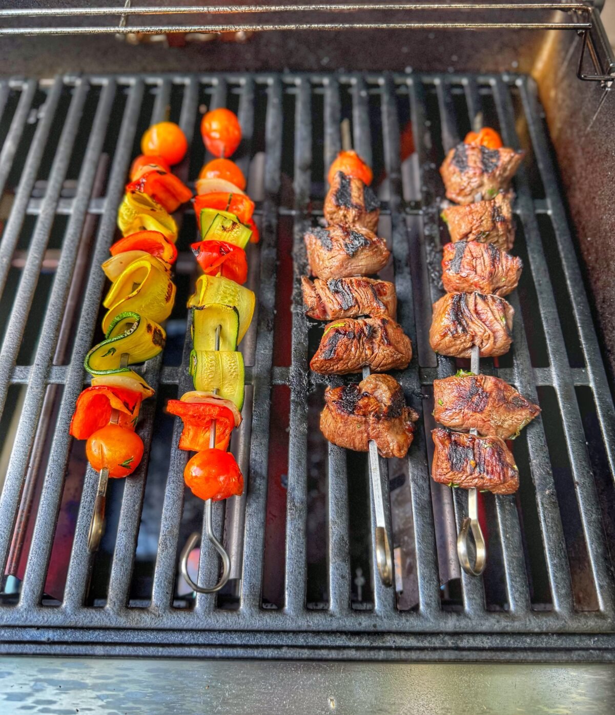 Steak and veggie skewers on the grill over medium-high heat.