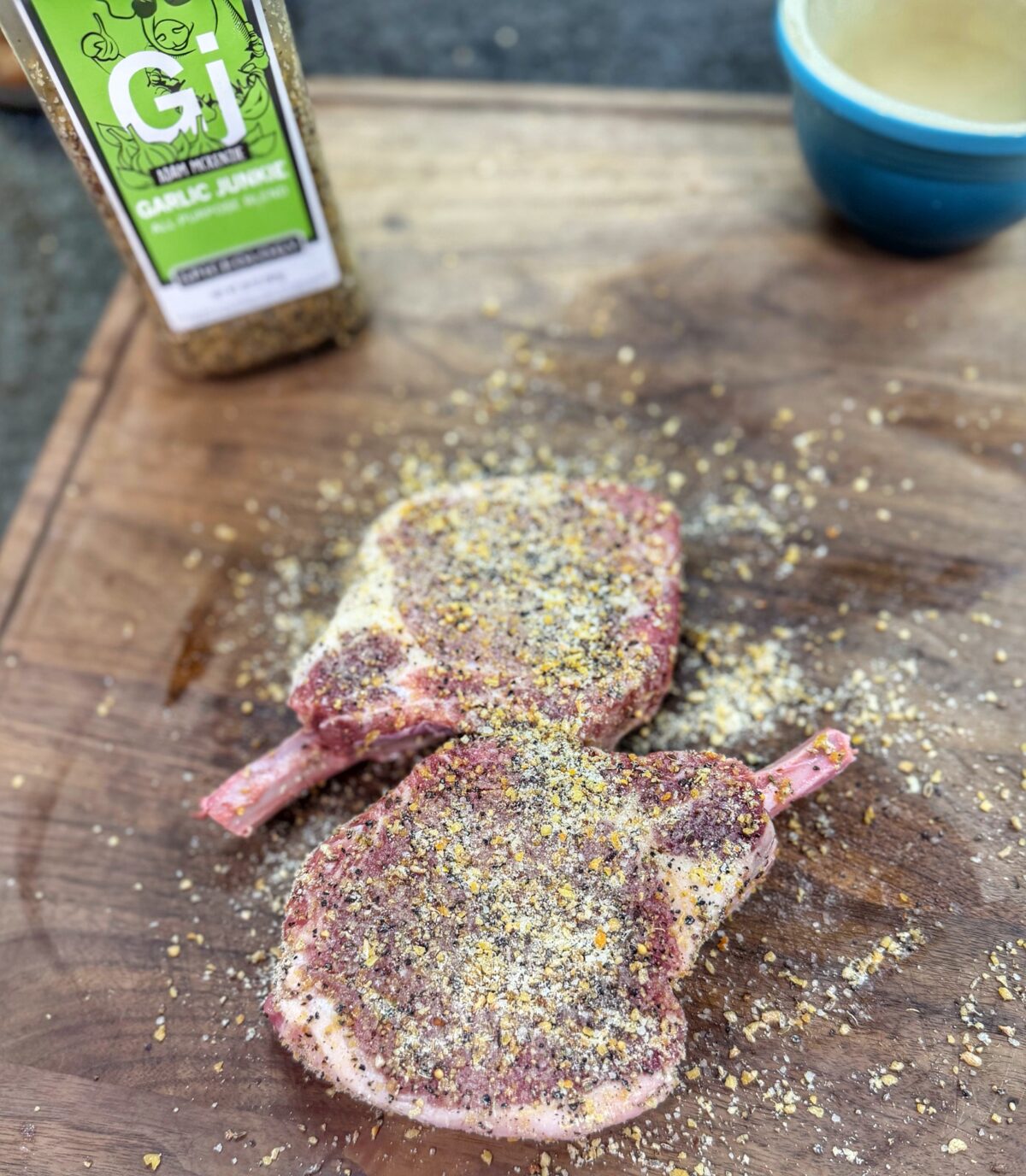 Bone-in pork chops seasoned with garlic seasoning and ranch powder before cooking.