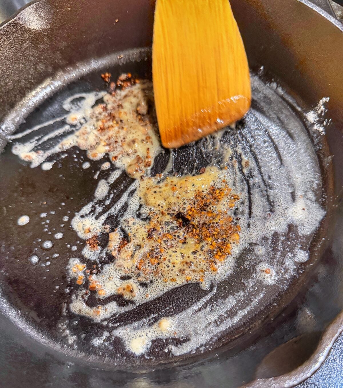 Butter and flour cooking in a cast iron skillet with pork drippings to start the ranch sauce.