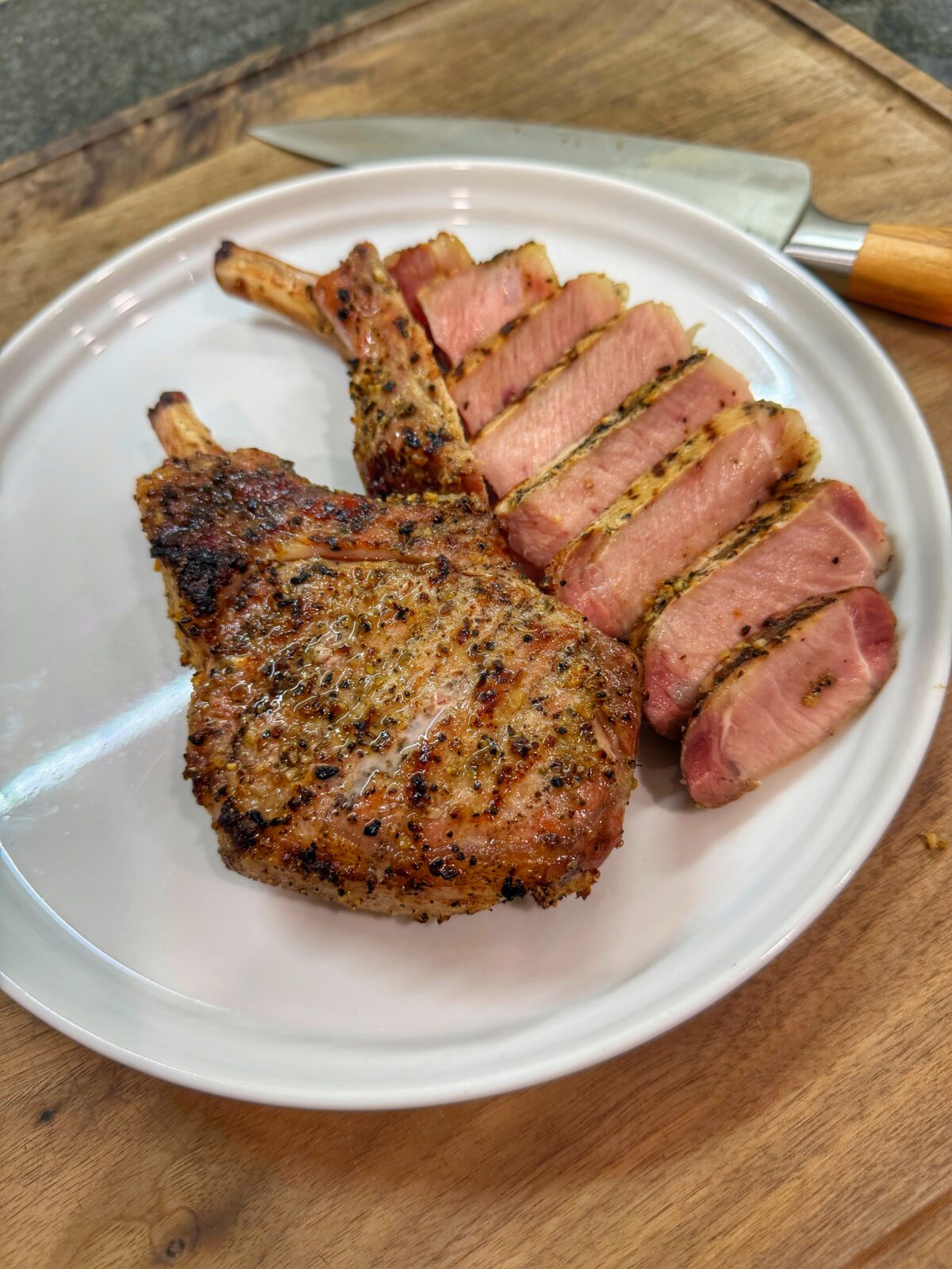 Sliced garlic ranch pork chops showing juicy interior after reverse searing.