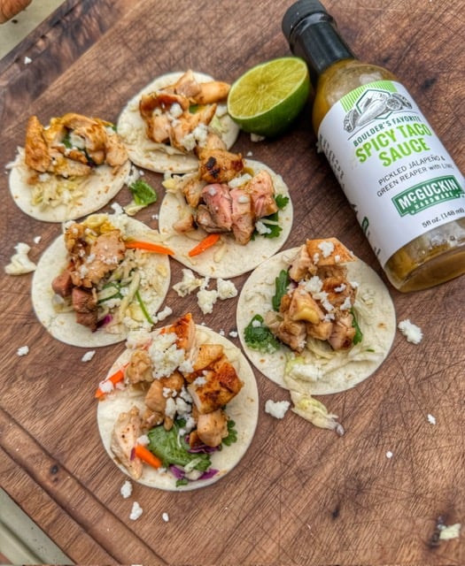 Mini grilled chicken tacos with cilantro slaw, cotija cheese and McGuckin Hardware Spicy Taco Sauce.