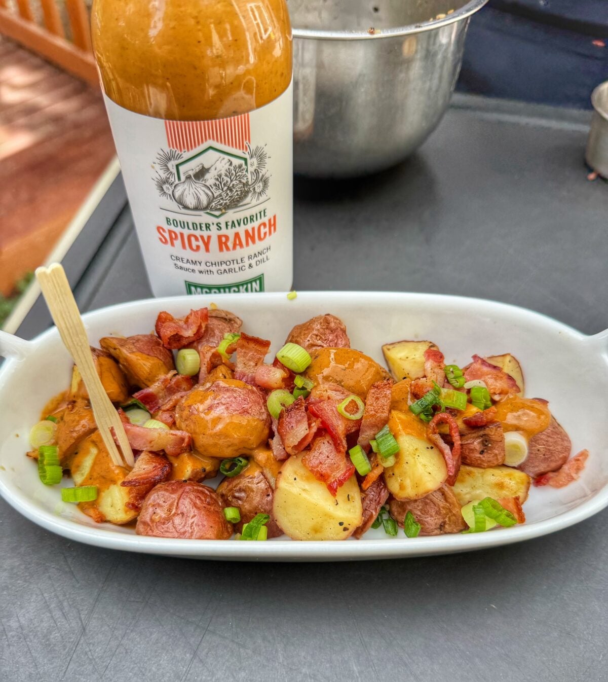 Grilled red potatoes tossed with McGuckin Spicy Ranch sauce, bacon and sliced green onions.