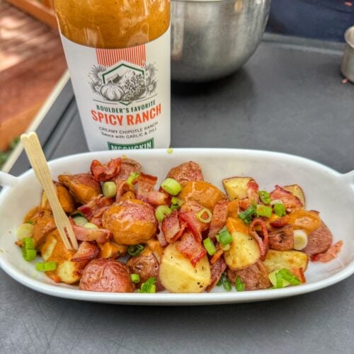 Grilled red potatoes tossed with McGuckin Spicy Ranch sauce, bacon and sliced green onions.
